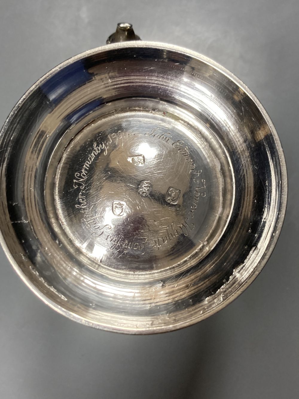 An early George III silver mug, with engraved crest and later embossed decoration, William Shaw II, London, 1764,